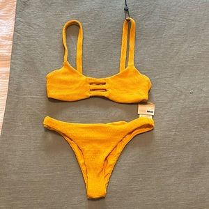 A yellow swimsuit it is an XS Has never been worn